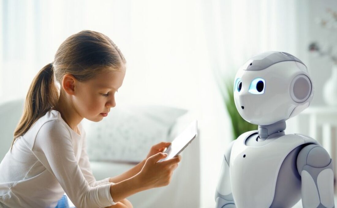 A child studying on a tablet with a humanoid robot beside her